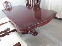 Full view of tabletop with carved molded edge and scalloped corners