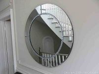 Full view of round beveled wall mirror on a wall, showing the crystal detail inner circle