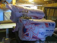 Stacked Pink Panther R-20 insulation bags with brass fixture on top