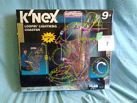 Front of the K'NEX Loopin' Lightning Coaster set box, showing colorful roller coaster model graphic, age 9+, and motorized feature.