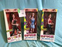 Three dolls in original boxes side by side showing full packaging and dolls inside.