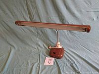 Front view of brown industrial retro table lamp with flexible gooseneck and rectangular shade, showing base and power cord.