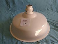 Image showing the industrial enamel light shade from an angled side view, highlighting the vented top collar and smooth enamel finish.