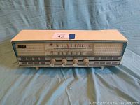 Front view of radio showing speaker grille, tuning dial with AM and FM bands, Hi Fidelity branding, and control knobs.