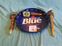 Oval Labatt Blue Pilsener metal beer tray with printed branding and slight wear visible
