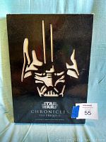 Black slipcover for the book, featuring a silver Darth Vader mask design and Star Wars Chronicles The Prequels title with author names.