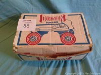 Original Dominion Sun-Line roller skates box top view with graphic illustrations of skates and red wheels.