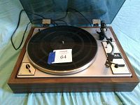 Full view of the Taya CP-300 turntable with dust cover showing the platter, tonearm, and control panel on wood base.