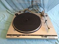 Front angle view of the Technics SL-D20 turntable showing platter, tonearm, and some control switches.