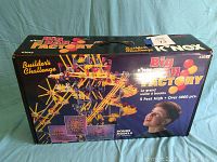 Front of original box showing K'NEX Big Ball Factory kit, model 63045, with an image of the constructed ball machine and a child looking at it.