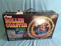 Box front showing K'Nex Roller Coaster set with piece count, dimensions, and color-coded construction.