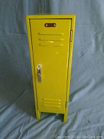 Front closed view of small yellow metal school locker with plaque number 221