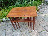 Three tables nested together, folded configuration