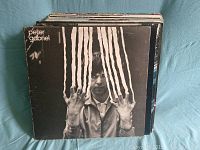 Photo showing the front cover of the Peter Gabriel vinyl record in the lot.