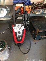 Top view showing handle and coiled power hose on the Husky power washer.