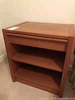 Front and side view of teak nightstand showing drawer and shelves