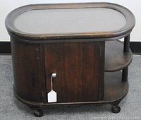 Full view of the rolling butler's side table, showing the door cabinet, shelving, and caster wheels