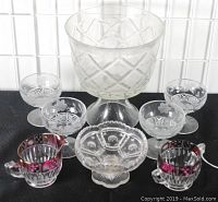 Set of all glass items together including desserts, creamer and sugar, compote, and trifle bowl