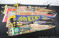 Photo showing a collection of pennants including Boston, Hampton Beach, Kent State, Gaslight Village, and more