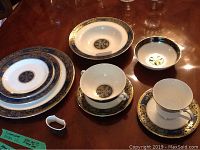 Assortment on table: dinner plate, salad plate, small bowl, soup bowl, coffee cup and saucer, teacup and saucer, napkin ring