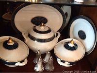 Overview showing three covered bowls, two plates and four shakers