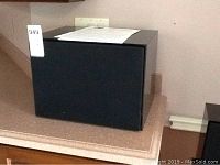 Large black NHT subwoofer with fabric grille and MaxSold lot sticker ‘949’