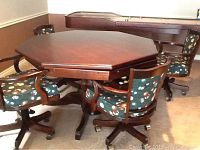 Full setup showing octagonal table top on solid wood pedestal and four swivel chairs around it