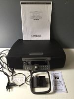 Full view of Cambridge Soundworks Radio CD 740 audio system with user manual and two antennas displayed on a white surface.