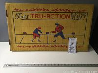 Closed box of Tudor Tru Action Electric Football Game showing vintage graphics.