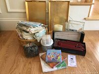 Full lot showing candles, linens, vases, trays, stones, and marbles placed on a wooden floor.