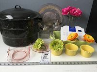 Lot of vintage and new-in-box kitchen and serving ware including enamel canning kettle, depression glass dishes, ceramic ramekins, glass vase, and napkin rings