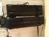 Pioneer AV receiver and Sony 5-disk CD changer stacked on wall shelf with cables visible.