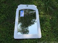 Full view of vintage rectangular mirror with white painted hardwood frame.