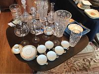 Full overview of porcelain and crystal items displayed on table