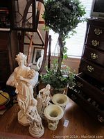 Overview showing topiary, three statues, two urn vases