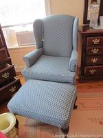 Blue Pembrook wing chair and matching ottoman together showing fabric pattern and wood legs