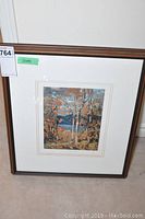 Full view of Algonquin October framed print with dark wood frame and white mat.