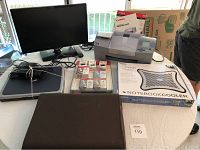 Overview photo showing HP laptop, Samsung monitor, Canon printer, notebook cooler box, and ink cartridges on table