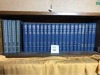 Photo showing 17 volumes of the McGraw-Hill Encyclopedia of Science and Technology in blue hardcover and 4 translucent binder sleeves containing yearbooks