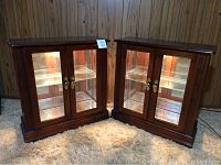 Two matching display cabinets shown side by side with lights on