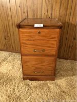 Front view of the wooden 2 drawer file cabinet showing the two drawers, brass handles, and lock mechanisms.