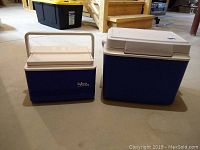 Image showing two coolers side by side on a basement floor, an Igloo 6 pack cooler on the left and a Rubbermaid 24 quart cooler on the right.
