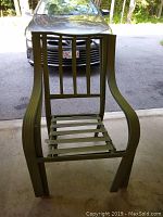 Two green metal patio chairs from front and side view, showing vertical back slats and horizontal seat slats, with armrests and weathered finish.