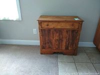 Front view of the antiqued wooden cabinet with visible drawer and paneled door