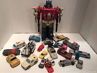 Full group of Transformers, including large Optimus Prime figure and smaller vehicles