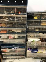 Front view of two stacked storage cases with multiple clear drawers containing plumbing and electrical supplies.