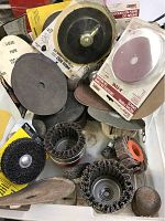 Overview image showing the assortment of sanding discs, grinding wheels, and wire brush attachments for drill.