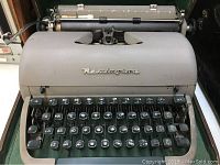 Front view showing Remington Letter Riter branded metal body with keyboard and keys in good condition.