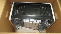 View of the Kero Sun kerosene heater packed inside original cardboard box showing the grill and metal body.