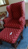 Roland red wingback chair with matching ottoman, showing fabric pattern and shape.